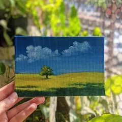 I painted this simple, serene landscape of a lone tree in a yellow field. It’s about finding joy in quiet moments and open spaces. The small canvas makes the big sky feel even more vast.