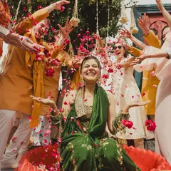 The bride's haldi had its own beautiful chaos. A flower shower from friends and family created this stunning, joyful moment of celebration.