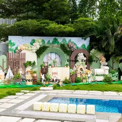 Advaith's woodland adventure set against a beautiful poolside backdrop. This outdoor party decoration shows a full-stage setup with a custom arched backdrop, 3D animal cutouts, hot air balloon props, and lush greenery, proving that any space can be transformed into a fantasy.
