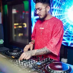 In the zone, crafting the perfect set. I use professional Pioneer DJ equipment to mix tracks seamlessly, reading the crowd to build energy and keep the dance floor alive. This is where the magic happens.