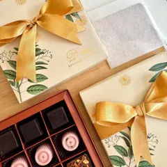 The art of gifting, perfected. This elegant box holds our artisanal chocolates, including rich coffee truffles, tangy cranberry chocolates, and crunchy almond praline truffles, all beautifully packaged for a memorable unboxing experience.