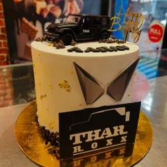 The perfect birthday cake for a Thar enthusiast. This design features a miniature Thar model, the Mahindra logo, and a personalized name, making it a unique and memorable centerpiece.