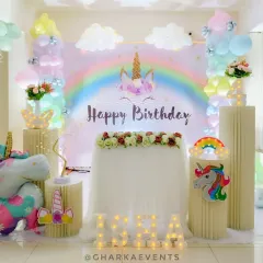 This dreamy unicorn-themed birthday setup is all about magic. It features a rainbow backdrop, pastel balloon clouds, a large unicorn foil balloon, and illuminated letters, creating a perfect photo opportunity.