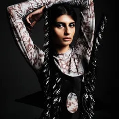 A powerful high-fashion look for a designer collection, featuring sharp, dark, winged eyeliner and a sleek, pulled-back hairstyle. The focus is on creating a strong, almost architectural facial structure.