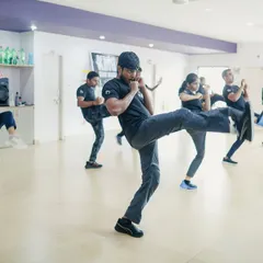 An instructor demonstrates a powerful defensive front kick during a Third Party Protection seminar in Mangalore. Our training emphasizes dynamic, full-body movements that are effective for creating distance and neutralizing a threat quickly.