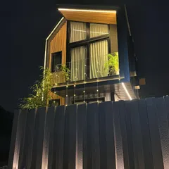 A look at a completed shipping container home at night. This project demonstrates how I transform industrial materials into warm, inviting, and sustainable living spaces with thoughtful lighting and design.