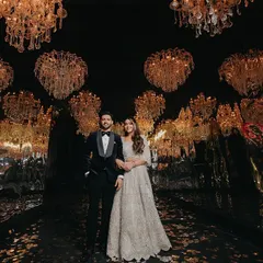 The decor of your event is part of your story. We captured this couple standing beneath a breathtaking ceiling of heart-shaped chandeliers, a testament to the opulent and romantic atmosphere of their cocktail night.