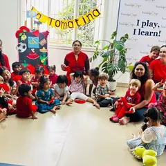 Our whole group together for our 'La Tomatina' celebration! We all dressed in red and learned about this unique Spanish festival through stories, crafts, and, of course, some messy tomato fun.