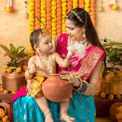 The timeless bond of Yashoda and Krishna. A mother shares a sweet moment with her little one, who is playfully stealing 'butter' during our Janmashtami session.