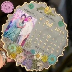 A lovely anniversary gift featuring a custom calendar for February 2014. The couple's photo and hashtag are preserved with a mix of colorful flowers against a soft grey background.