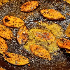 Tandoori seer fish being fried on a large tawa. This is part of our traditional Kutchi Memon menu, offering a delicious seafood option for your event.