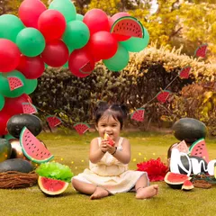 This little one is enjoying a slice of watermelon, a cute and candid moment from her outdoor birthday session.