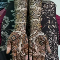 This full-arm design combines geometric shapes with floral patterns. The contrast between the bold, dark flowers and the delicate line work creates a balanced and eye-catching bridal style.