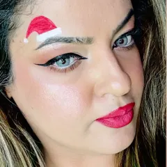 A close-up of my Christmas makeup look. Why wear a hat when you can just draw one on your eyebrow for a fun and unique festive style?