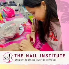 Safe removal is just as important as application. This student is learning the correct technique for overlay removal to protect the natural nail.