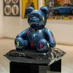 'Ted – Ode To Keith Haring' displayed in our gallery. This view shows the sculpture in context with other works, demonstrating its presence as a contemporary pop art piece.