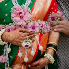 A close-up detail shot of the beautiful floral jewellery, or 'phoolanche dagine', worn by the mother-to-be, highlighting the traditional elements of a Maharashtrian baby shower.