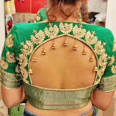 The beauty is in the details. This custom designer blouse features a dramatic arched keyhole back, framed with intricate gold zardosi embroidery and delicate hanging jhumkas. I work closely with clients to create unique back designs that make their ethnic wear truly one-of-a-kind.