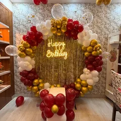 This classic and elegant circular balloon frame is one of my most popular designs for birthdays. The combination of metallic gold, rich red, and crisp white balloons, centered around a glowing neon "Happy Birthday" sign and a gold fringe backdrop, creates a perfect photo opportunity for any age.