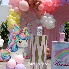 A close-up of the unicorn party decor, featuring a cute unicorn cutout and a custom-printed plinth with the birthday girl's name.