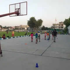 Young skaters practicing their balance and movement on the outdoor court. Cones are used to guide them through basic skating drills.