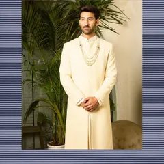 My off-white sherwani, styled with a traditional multi-layered pearl necklace. The simplicity of the garment allows for accessorizing, making it a versatile choice for a modern Maharaja.