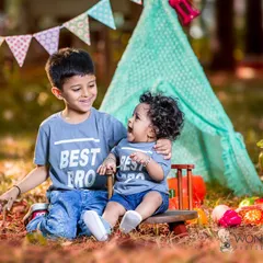 The pure love between brothers shines through in this outdoor sibling photoshoot. Set against a playful teepee backdrop, their matching "Best Bro" shirts and genuine laughter make for a priceless memory.
