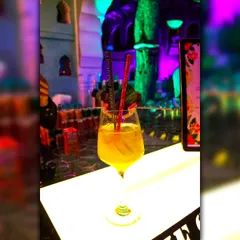 My 'Mango Manifested Love' cocktail, a tropical delight served in a wine glass. It's a perfect, refreshing choice for daytime events and summer weddings.