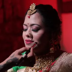 A close-up of lipstick application, a fundamental skill for any makeup artist. I teach precision techniques using different tools, like this brush, to achieve a clean, professional lip line every time.