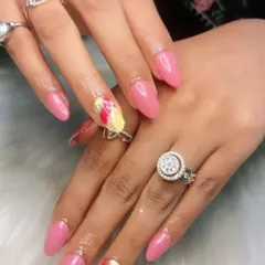 A bright and cheerful pink manicure with a colorful abstract accent nail. This is a great way to add a pop of personality to a classic look.