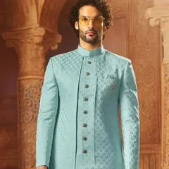 This light blue Indo-Western sherwani has a subtle texture and a modern cut. It's a sophisticated choice for a day wedding or an engagement ceremony.