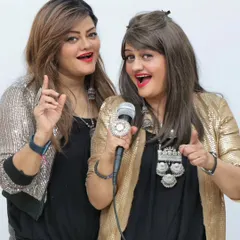 A fun and posed shot showcasing our 'sister duo' dynamic. Our coordinated outfits with sequined jackets are perfect for a glamorous Bollywood or corporate event.