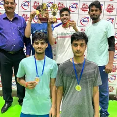 Celebrating a doubles victory. These players are holding their trophies and medals, showcasing the teamwork and coordination we develop in our training.