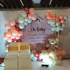 A sweet 'Oh Baby' shower setup with a 'Twinkle Twinkle Little Star' theme. The decor includes a pink backdrop, a balloon garland in rose gold and white, and a cute teddy bear.