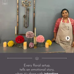 Every floral setup tells an emotional story when it's done with intention. This student stands by her work, a carefully composed scene using candles and monochromatic floral spheres to create a serene mood.