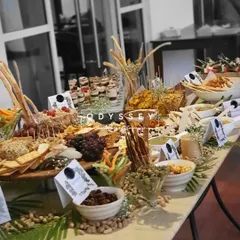 An elegant grazing table setup featuring a variety of crackers, breadsticks, nuts, and dips. The careful arrangement and use of fresh baby's breath flowers add a touch of sophistication, making it ideal for corporate events or chic parties.