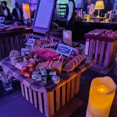Another angle of the cheese board, highlighting the vibrant colors of sliced watermelon and fresh strawberries alongside different types of cheese. We focus on using fresh, high-quality produce to make our grazing tables stand out.