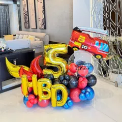 Sound the alarm! This firetruck-themed bouquet for a 5th birthday is full of action, featuring a large fire department truck balloon and bold HBD letters.