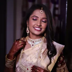 This close-up shows the details of the eye makeup and how it complements her beautiful ruby and diamond necklace.