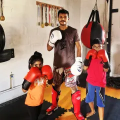 Look at these future champions. I focus on building confidence that goes beyond the gym. Putting on the gloves for the first time is a big step, and I'm here to guide them through it.