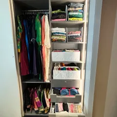 This sliding wardrobe features a series of organized drawers and shelves. We used a combination of hanging, folding, and binning to create a comprehensive system that addresses every type of clothing and accessory.