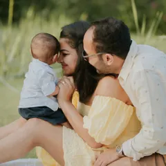 An incredibly sweet and intimate moment between parents and their baby. The gentle nose-to-nose touch is a perfect expression of family love.