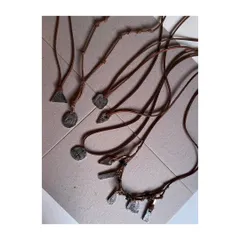 I also create handmade accessories. These are Nordic-inspired pendants I crafted from brass, hand-carving symbols and finishing them with an oxidized coating for an ancient, weathered look.