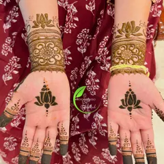 A bold and modern design featuring a prominent lotus motif on both the palm and the back of the hand, with filled fingertips.