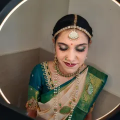 A close-up of Shalini's Muhurtham makeup, captured under a ring light to show the detail. I created a dramatic smokey eye with a touch of green shimmer to match her saree, paired with a deep magenta lip.