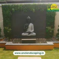 We design gardens that reflect peace and personality. Here, a vertical garden serves as a living frame for a tranquil Buddha statue and water feature, creating a dedicated space for meditation and relaxation in a residential backyard.