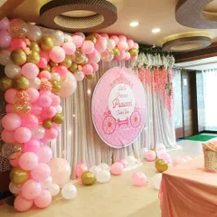 A closer look at the princess-themed backdrop, showing the detail in the pink and gold balloon arch. The arrangement includes varying balloon sizes and confetti-filled accents to add texture and sparkle to the party decor.