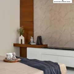 This bedroom design focuses on a calm, neutral palette. The textured wall paneling behind the floating media unit adds subtle interest, while the blend of wood and white keeps the space feeling light and airy.