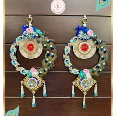Our peacock Shubh Laabh hangings are a masterpiece of luxury and tradition. We use real peacock feathers, lustrous pearls, and detailed embroidery to create these auspicious pieces that bring grace and good fortune to your home.