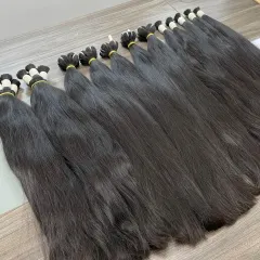 As a direct manufacturer, I source and process premium raw Indian Remy temple hair. This image shows bundles of our high-quality, unprocessed hair ready to be made into extensions, wigs, and toppers for my wholesale clients.